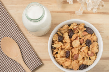 Corn flakes nutrition cereal and milk on wooden surface for healthy breakfast, Top view