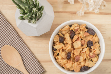 Corn flakes nutrition cereal and milk on wooden surface for healthy breakfast, Top view