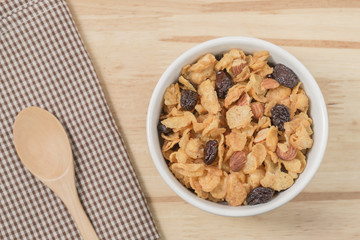 Corn flakes nutrition cereal and milk on wooden surface for healthy breakfast, Top view