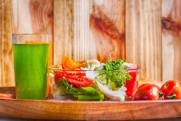 healthy foods are on the table, Fresh vegetable salad in a glass