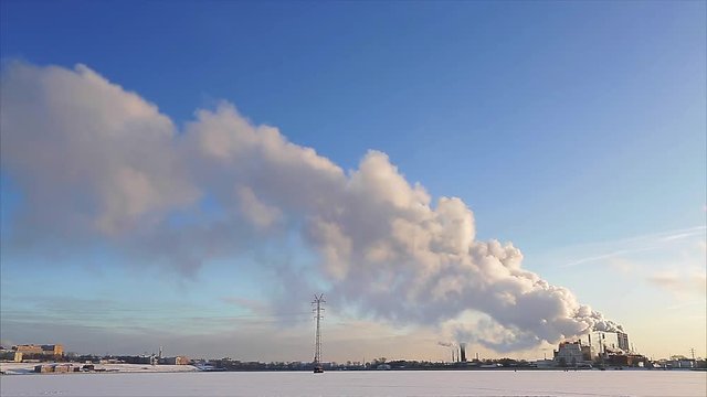 Factory with smoke goes from pipe at winter