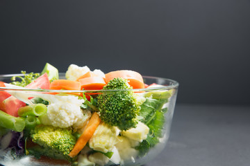 healthy foods are on the table, Fresh vegetable salad in a glass