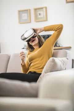 young woman uses a virtual reality glasses, VR mask