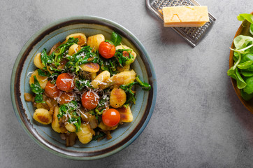 Gnocchi with spinach, garlic and tomatoes - obrazy, fototapety, plakaty