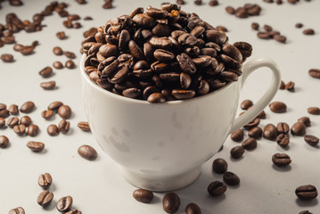 Coffebeans on Neutral Gray Background. Dark Roast Coffee. White