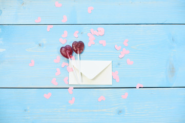 Lollipops with letter around heart shaped confetti...