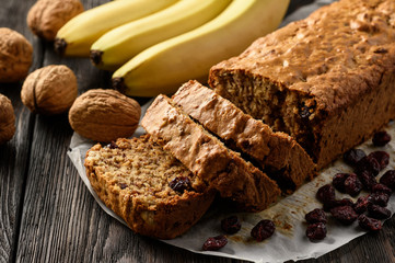 Homemade banana bread on wooden background.