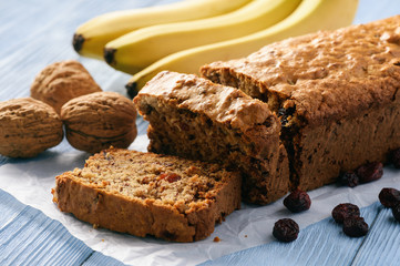 Homemade banana bread on wooden background.