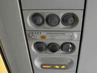 Individual lighting and fans are mounted in panel above passenger seats in cabin. Illuminated display 
