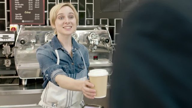 Barista serving business man in cafe