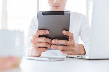 Cropped picture of young man using tablet computer