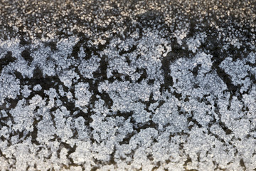 Beautiful frozen texture on a wooden surface. Crystal art from nature. 