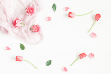 Frame with rose flowers and tulip. Flat lay, top view