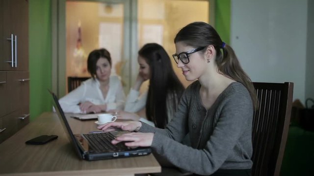 Girl puts glasses on laptop keyboard