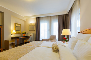 Interior of a new modern hotel double bed bedroom
