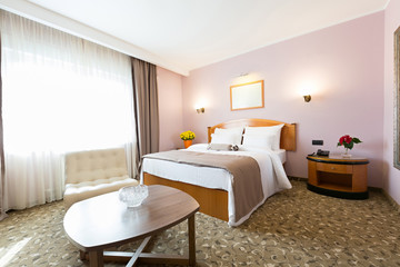 Interior of a new modern hotel double bed bedroom
