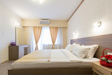Interior of a new hotel bedroom with master bed