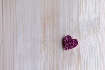 One tender pink heart are at a distance from each other on Valentine's Day, Valentine's Day, on a wooden background