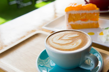 coffee cup and Delicious orange cake in coffee shop