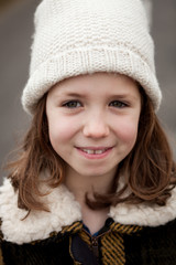 Beautiful girl with wool hat at winter