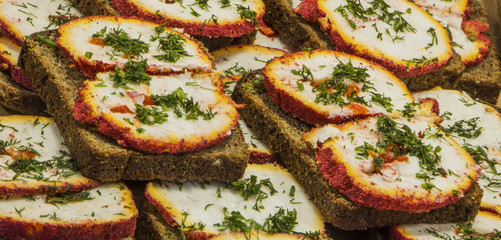 sandwich black bread with meat, cheese and herbs