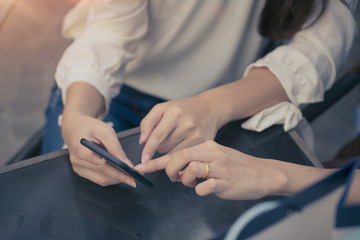 Two Women Sending Messages with Mobile.