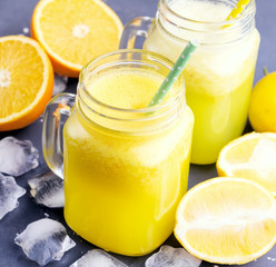 Orange and lemon juice in jars