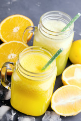 Orange and lemon juice in jars