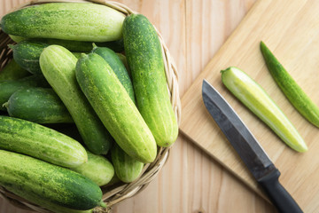 Fresh cucumber and slices on wooden table..