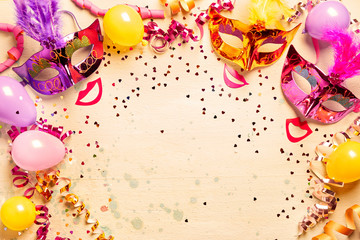 Frame of metallic Mardi gras masks and streamers