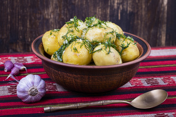 Boiled potatoes with dill and garlic in butter on a plate