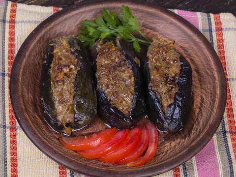 Baked eggplant stuffed with onions, cherry plums and walnuts