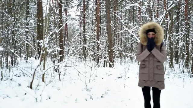 Group of young people standing in the forest in different frozen poses on cloudy winter day