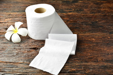 White tissue paper and white flower put on the old bark, wood at the morning