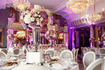 Table number 5 decorated with pink and violet hydrangeas and ser