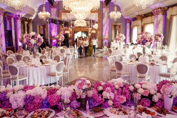 Look from behind dinner table decorated with garland of pink and