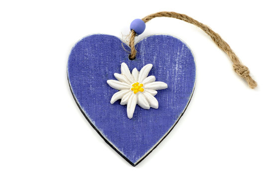 blue wooden heart shape with eidelweiss flower