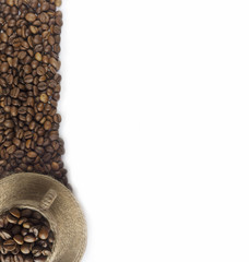 Coffee beans and a cup at border of image with copy space for text. Coffee background or texture...