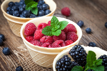 Blackberries, raspberries and blueberries in a waffle bowls.
