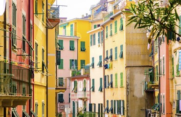 Riomaggiore village, La Spezia, Liguria, northern Italy. View of the colourful houses on steep hills and laundry on balconies. Part of the Cinque Terre National Park and a UNESCO World Heritage Site.