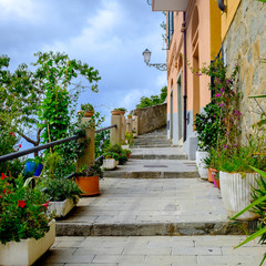 Picturesque walking alley climbing up in Riomaggiore, Cinque Terre.