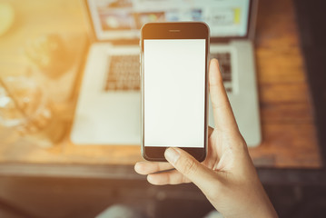 Hand holding smartphone white screen.