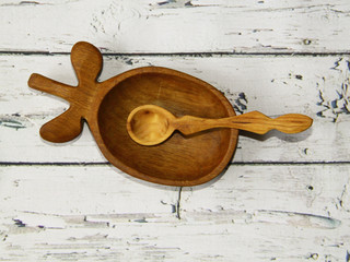 Beautiful kitchen wooden plate with a spoon on the table, still