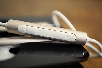 Macro detail of a silver volume controlling button (volume rocker) with plus and minus symbols...