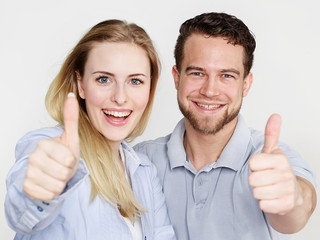Happy couple showing thumbs up