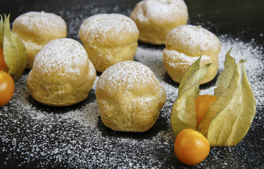 Delicious profiteroles with cream and chocolate glaze