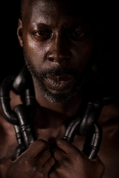 Portrait Of African Slave With Large Heavy Chain Around His Neck.