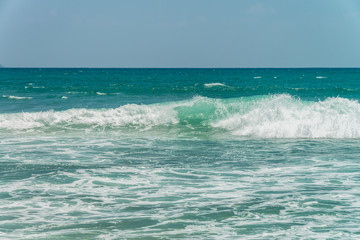 Sunny beach near Koggala - Sri Lanka The area famous for its distinct stilt fishermen, who erect a single pole in the chest-deep water on the beach, just few meters off-shore. Splittoned, vivid image.
