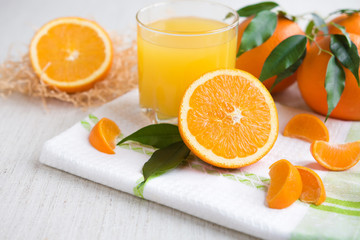 Obraz na płótnie Canvas Fresh orange juice in a glass on a background of fruit baskets