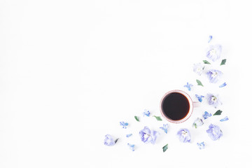 Cup of coffee, lilac flowers. Flat lay, top view
